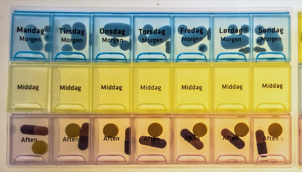 Tablet dispensers in three colours with weekday labels