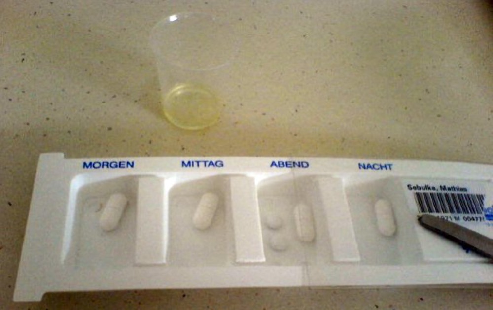 Daily pill dispenser with morning, midday, evening and night compartments