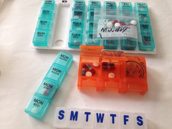 Teal and orange daily pill strips lettered S M T W T F S