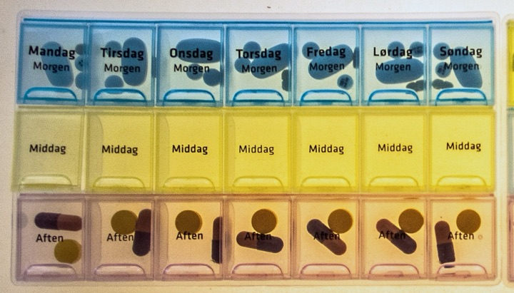 Tablet dispensers in three colours with weekday labels